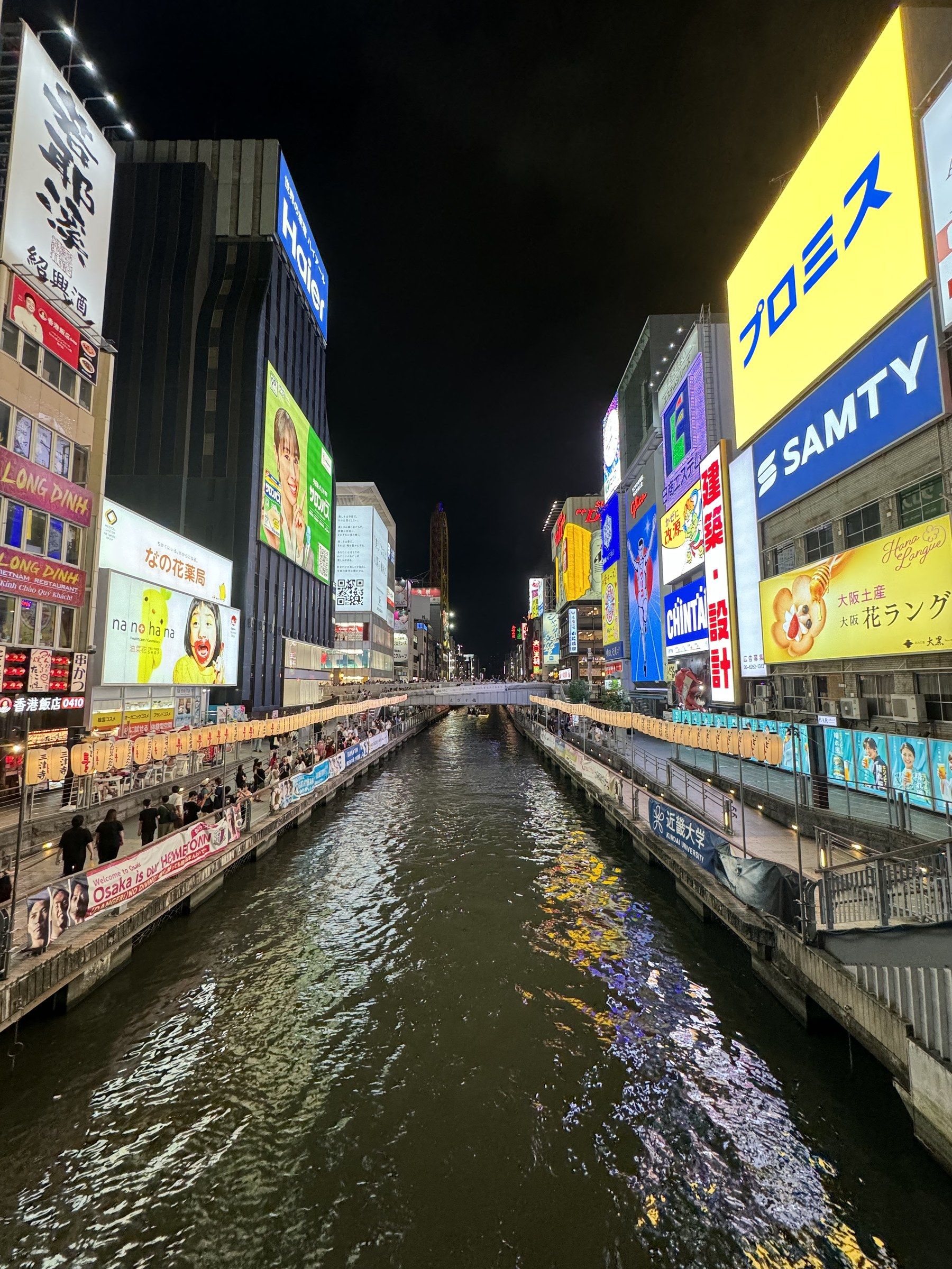 Dotonbori canal in Osaka at night, lined with neon billboards