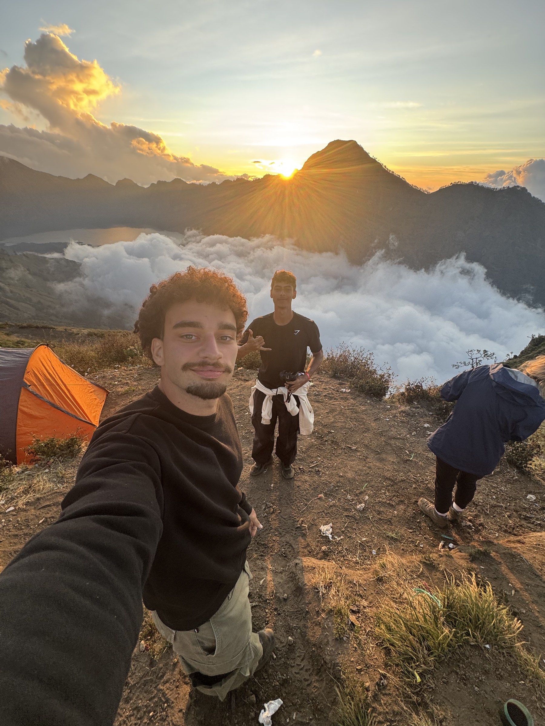 Selfie at the Rinjani crater rim camp with the sun setting behind the peaks