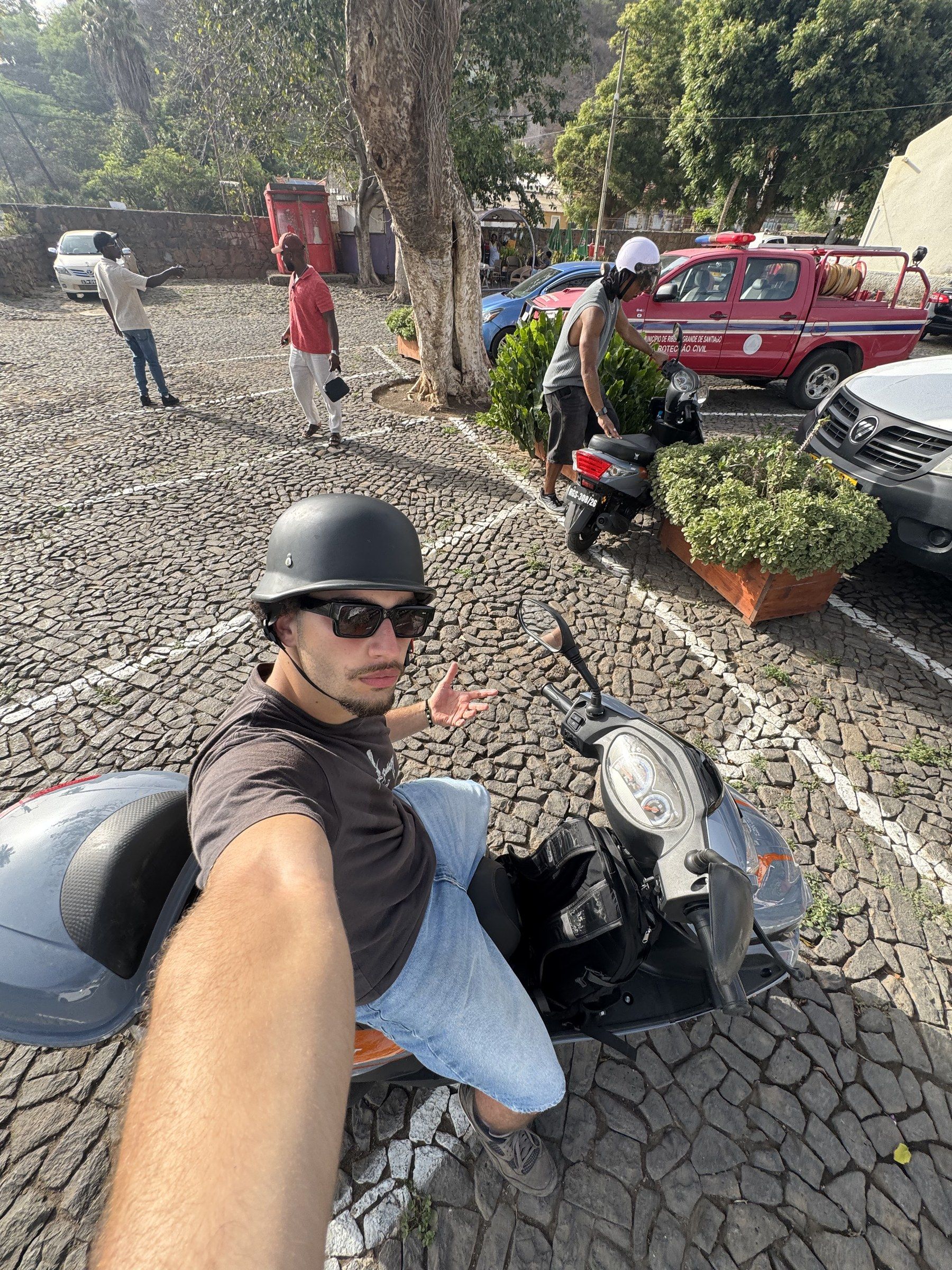 Selfie on a scooter on a cobblestone street in Cape Verde